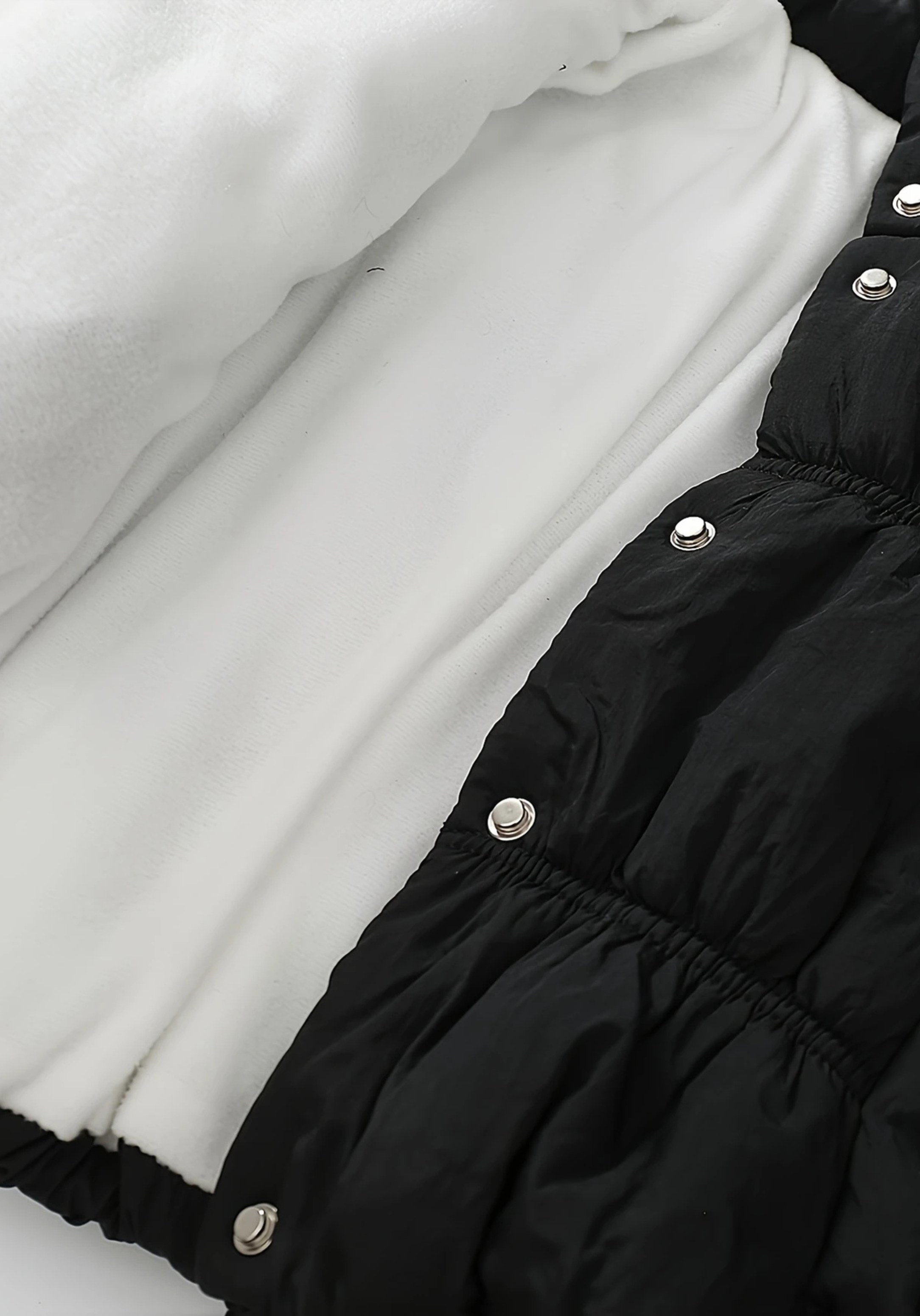 Inner view of toddler black puffer jacket with ruched detailing and high collar