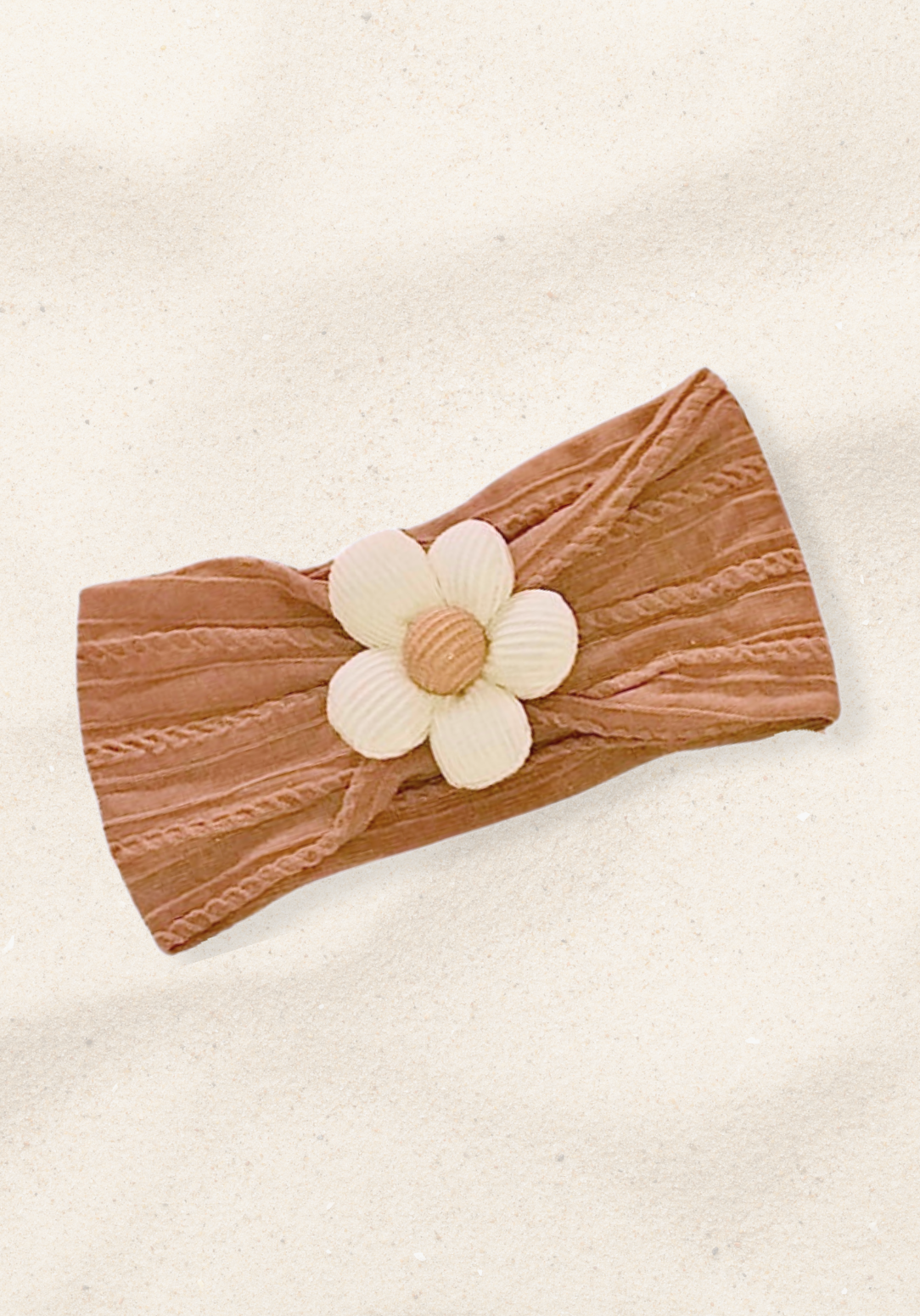 Rust toddler head band with a soft fabric daisy embellishment in the center.