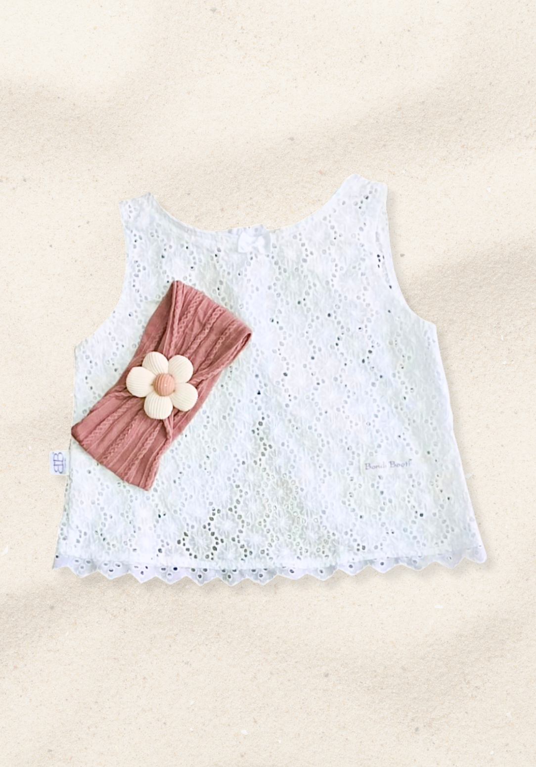 Rust toddler head band with a soft fabric daisy embellishment in the center.