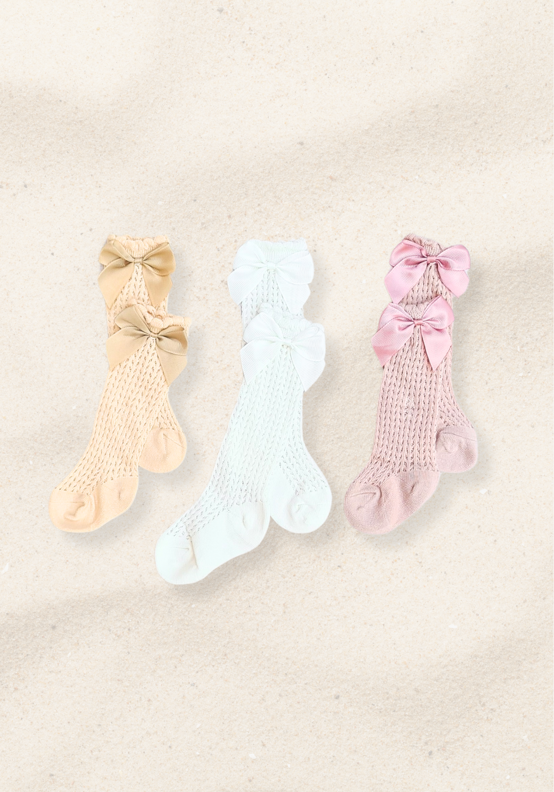 Set of three baby girl knee-high socks in beige, white, and pink with large decorative bows