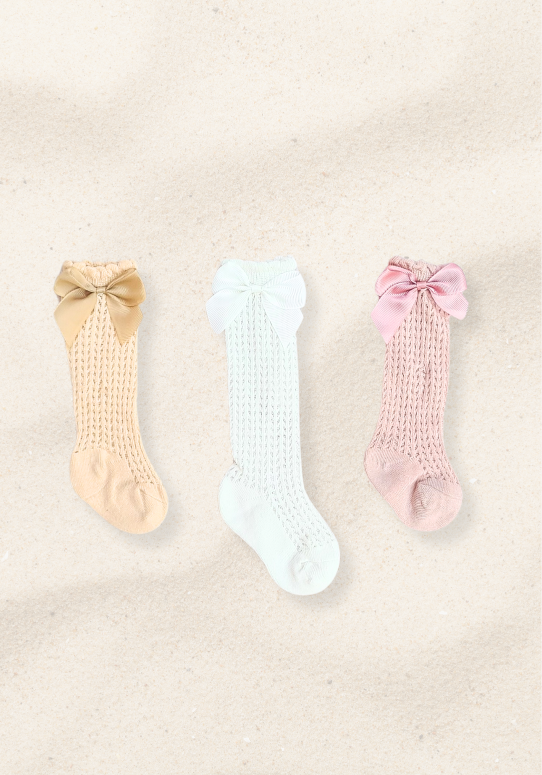 Set of three baby girl knee-high socks in beige, white, and pink with large decorative bows