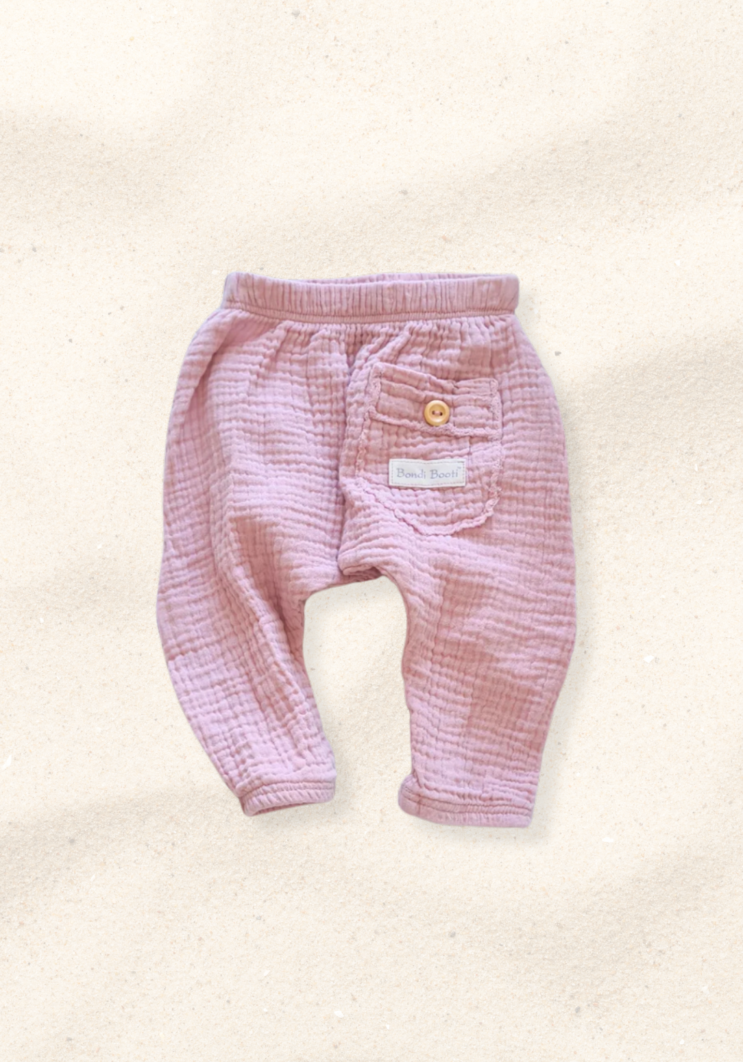 Organic cotton toddler harem pants in dusty pink with soft, breathable fabric and elastic cuffs.