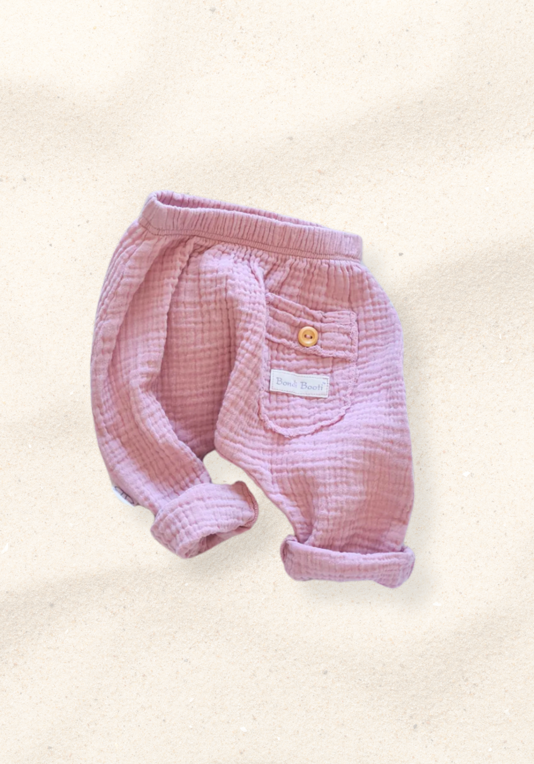 Organic cotton toddler harem pants in dusty pink with soft, breathable fabric and elastic cuffs.