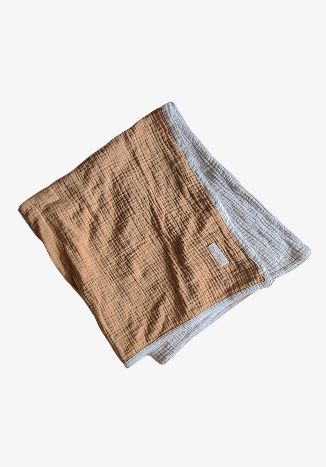 Reversible baby blanket in warm brown and white organic cotton, with visible Bondi Booti and “Made in Australia” labels, displayed on a neutral fabric background.