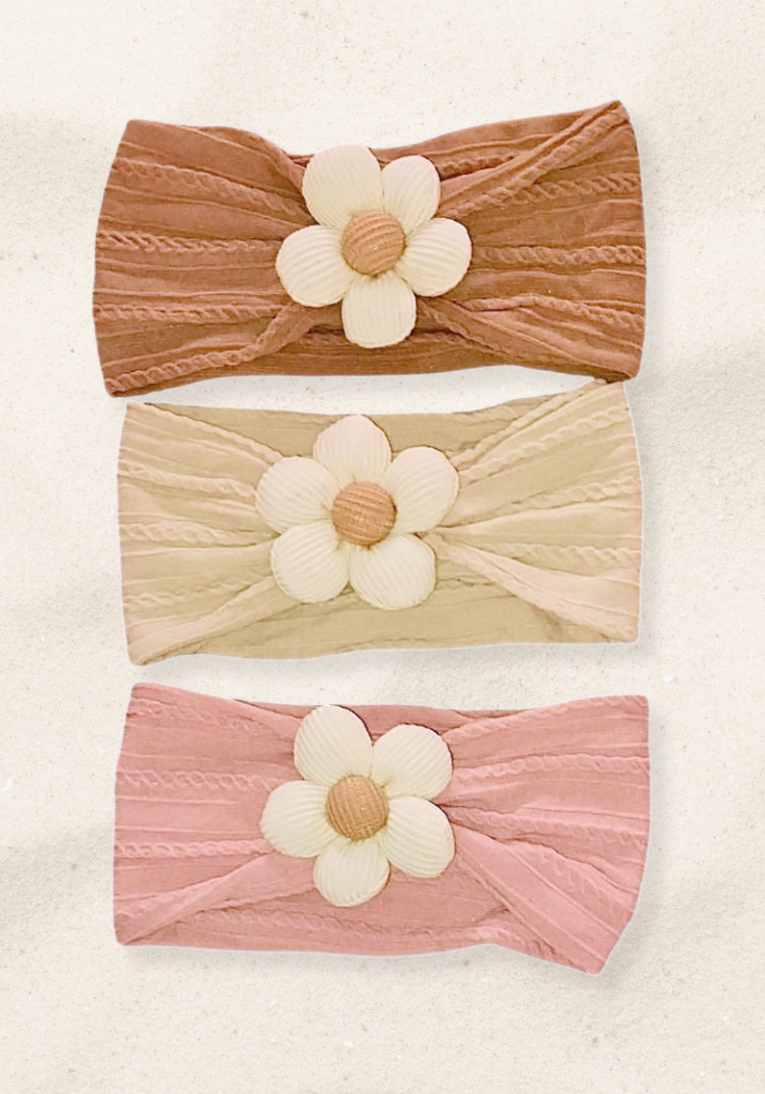 Oat-colored toddler head band with a cream daisy flower sewn at the center.