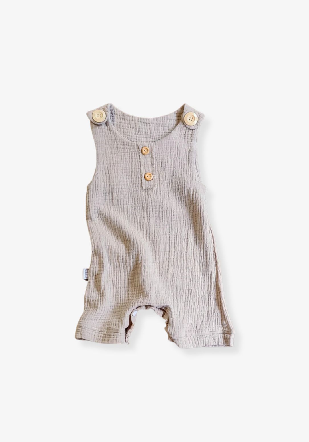 Beige organic cotton baby overall onesie with wooden button straps and soft elastic leg openings