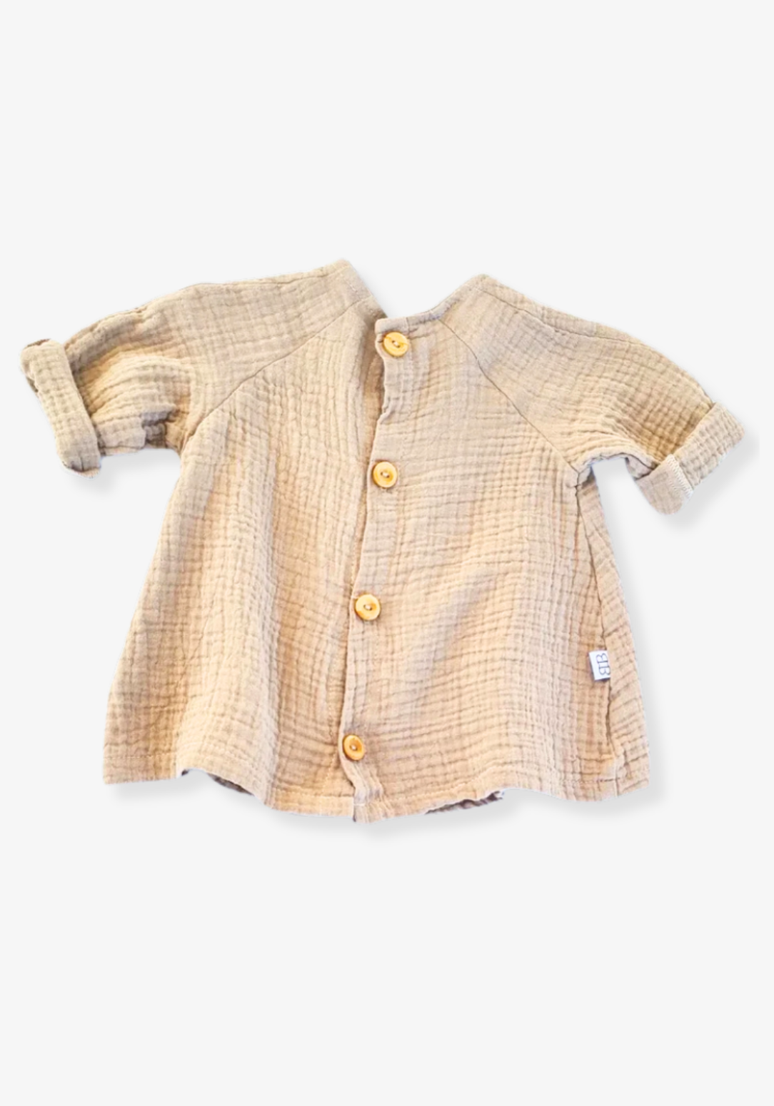 Mocha-colored cotton boho baby dress with embroidered hem, displayed on a light grey background for a neutral look